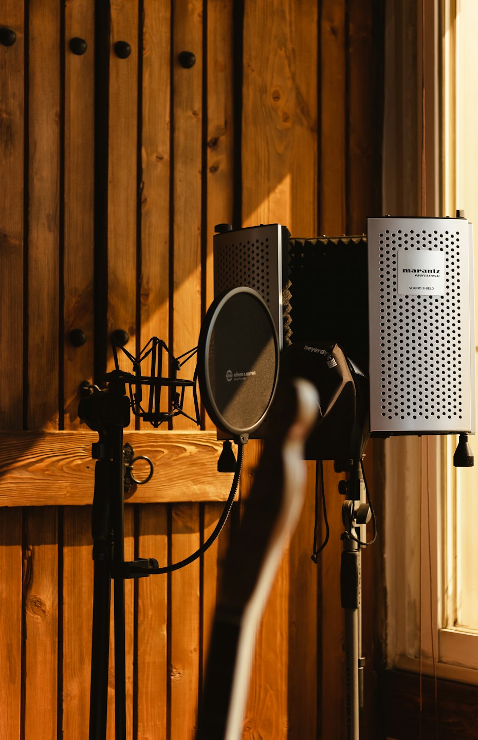 Professional microphone and sound shield in a recording studio.
