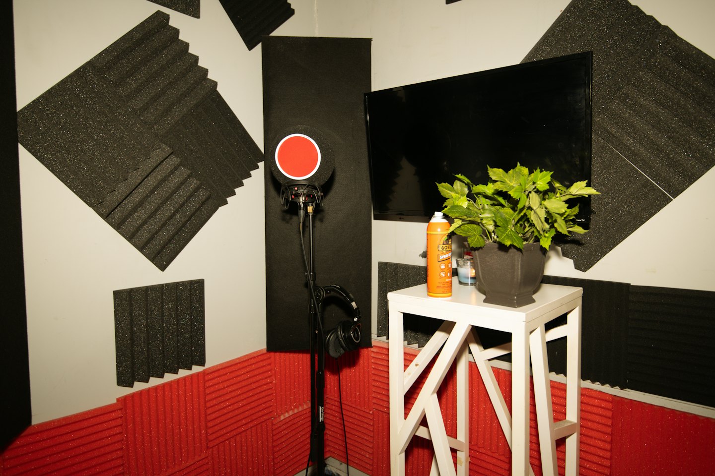Microphone, headphones, and monitor in a home recording studio.